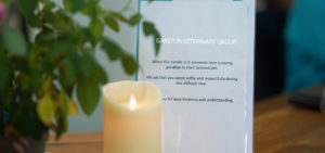 Lit candle and bereavement notice